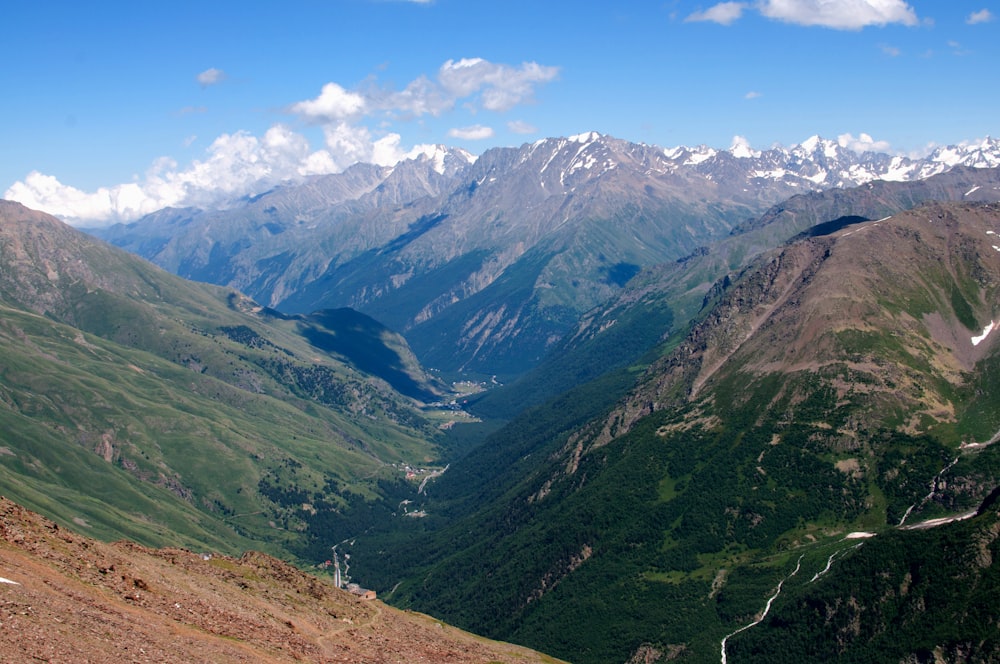 a view of a valley with mountains in the background