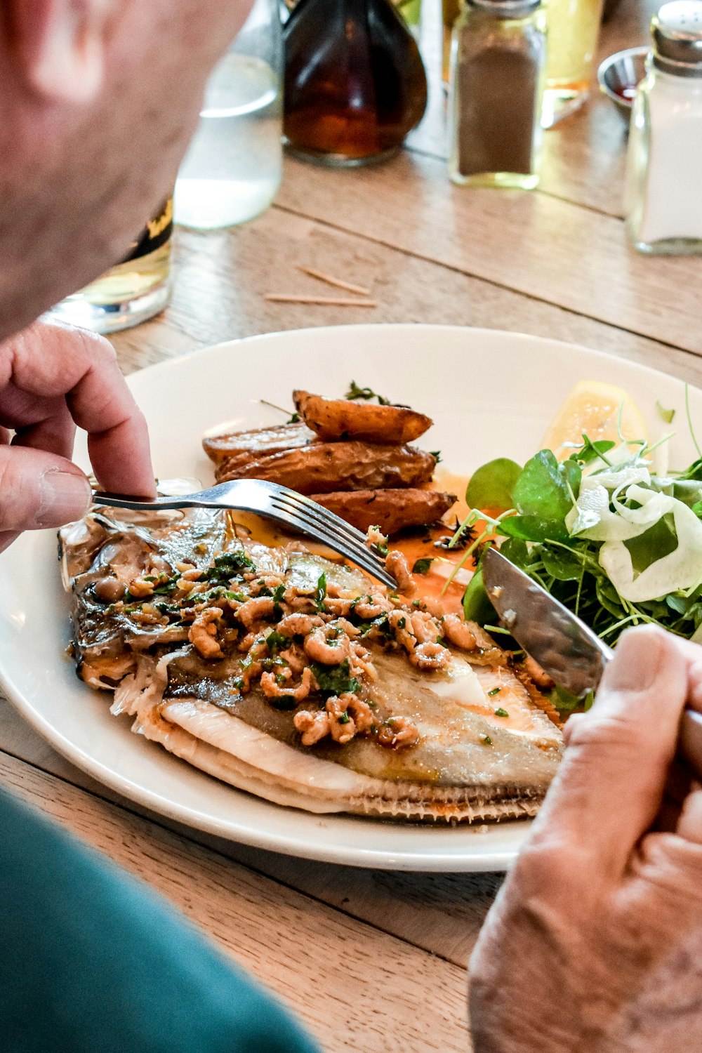 a man is eating a plate of food at a restaurant