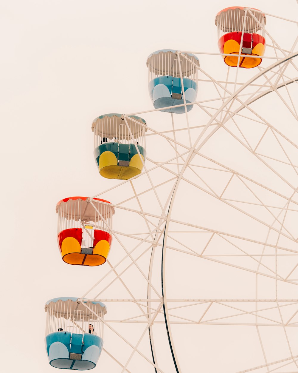 a ferris wheel with colorful seats on top of it