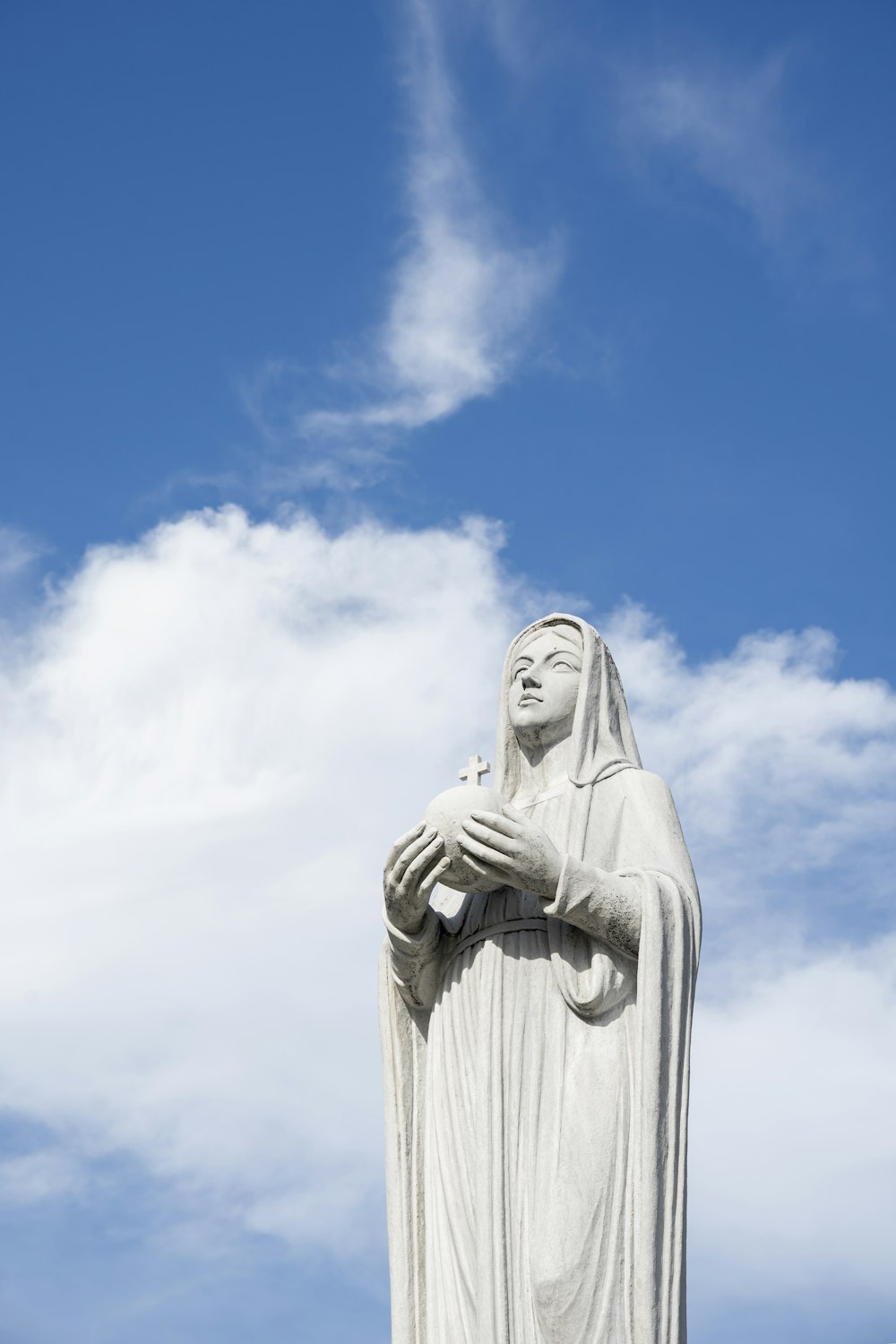 a statue of a woman with her hands together