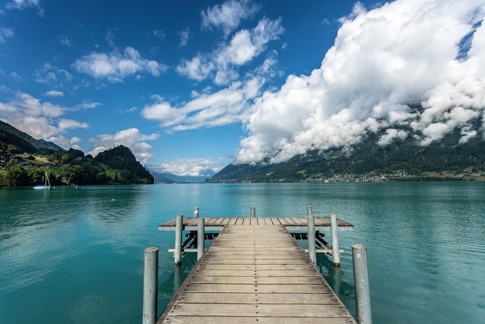 a dock on a lake with mountains in the background