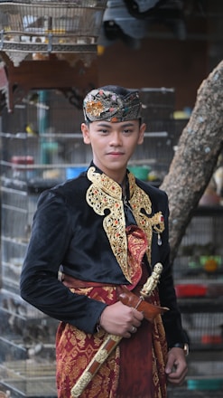 a man in a costume standing in front of a bird cage