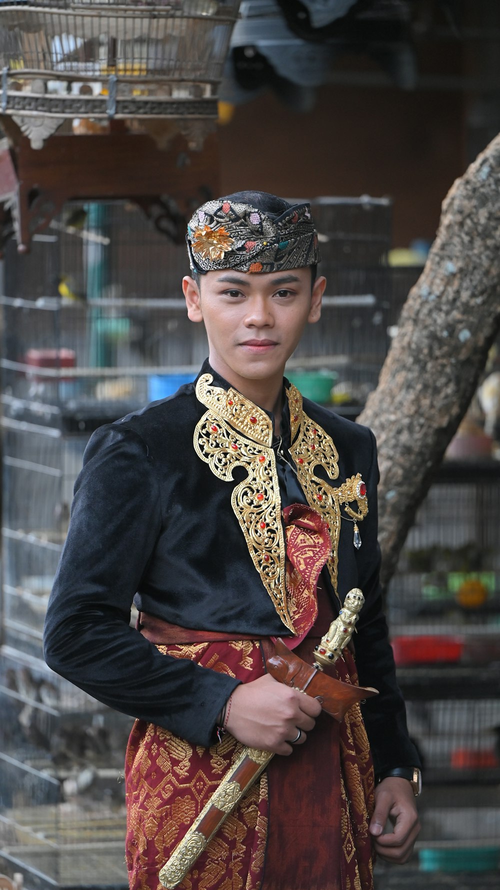 a man in a costume standing in front of a bird cage