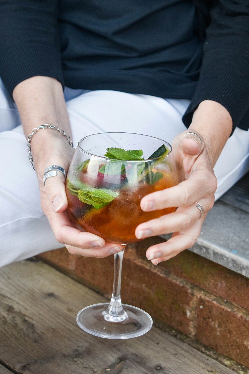 a close up of a person holding a drink