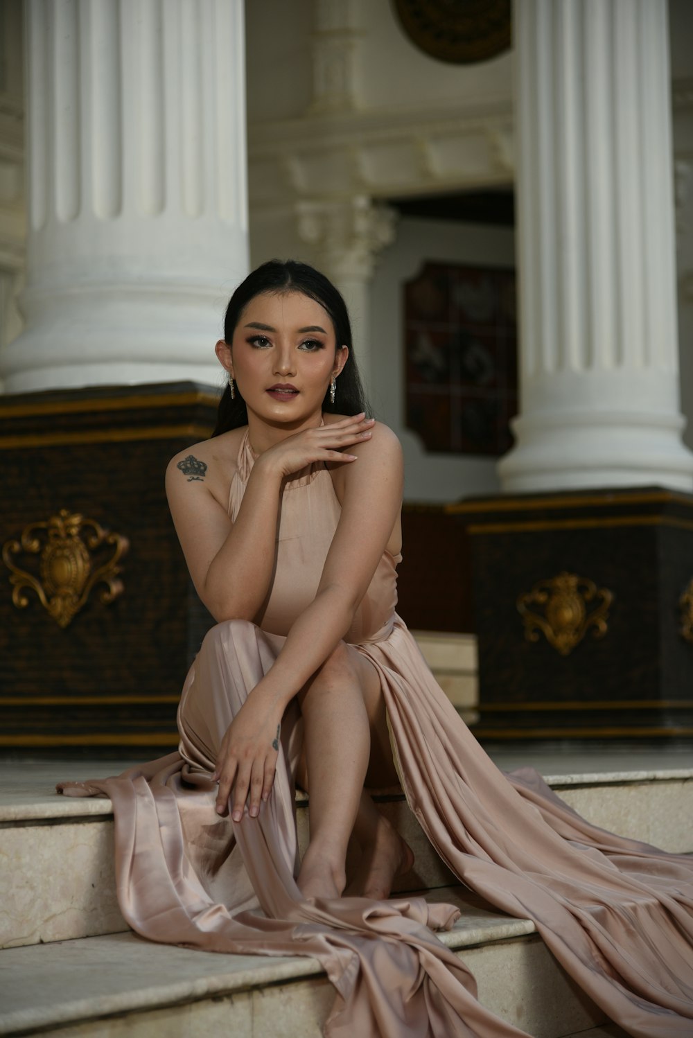 a woman sitting on the steps of a building