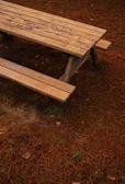Set of colorful wooden boards arranged on a picnic table outdoors