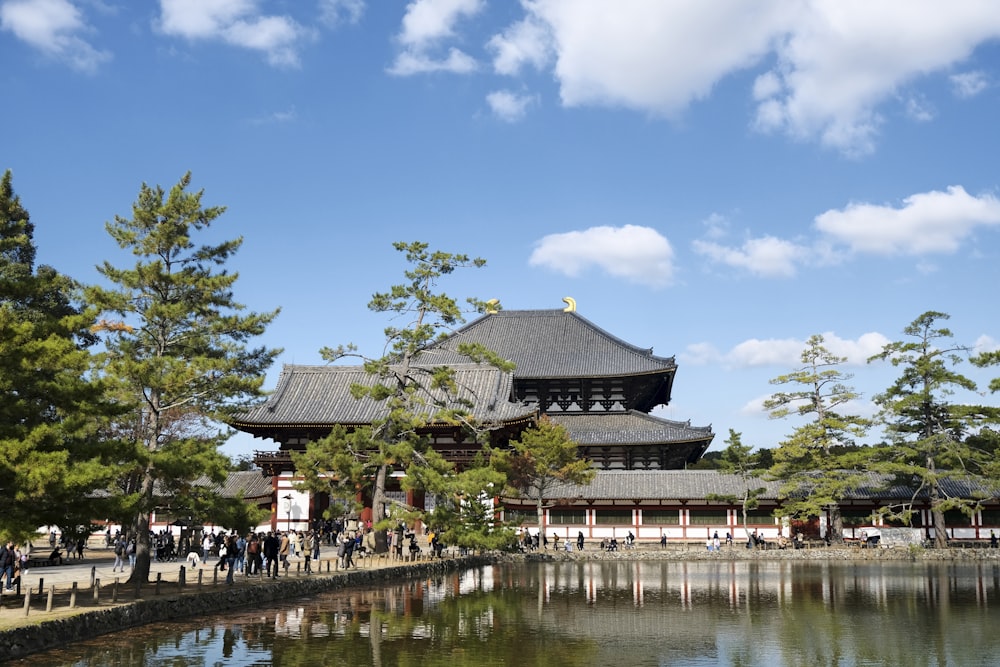 a large building with a pond in front of it