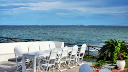 A tranquil scene of a private event set up near the water's edge.