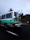 Group of friends laughing on a colorful bus heading to Isla Tortuga under a bright blue sky