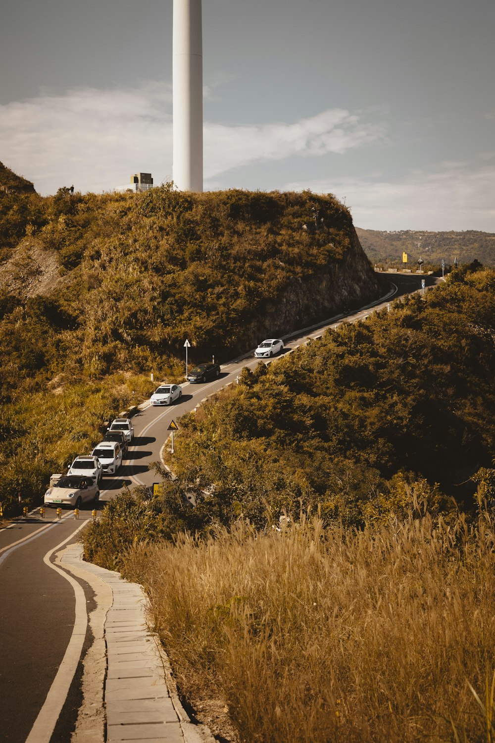 a view of a road with a tower in the background