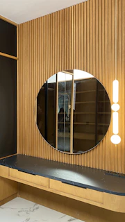 Detailed view of a large mirror with integrated lighting reflecting the salon’s modern design.