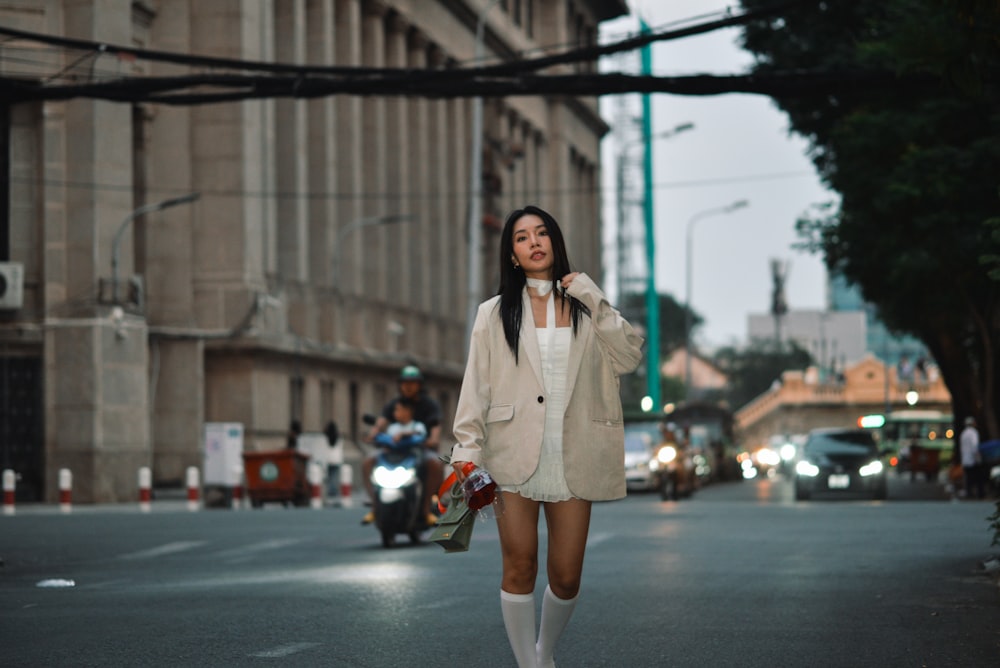 a woman walking down a street while talking on a cell phone