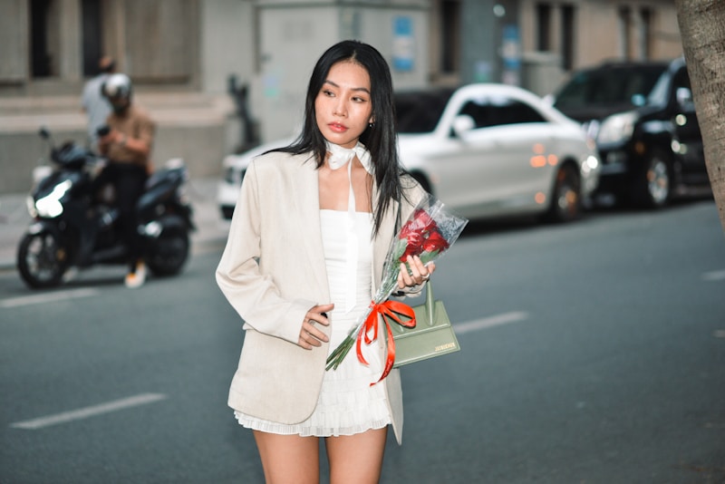 a woman in a white dress holding a bouquet of flowers