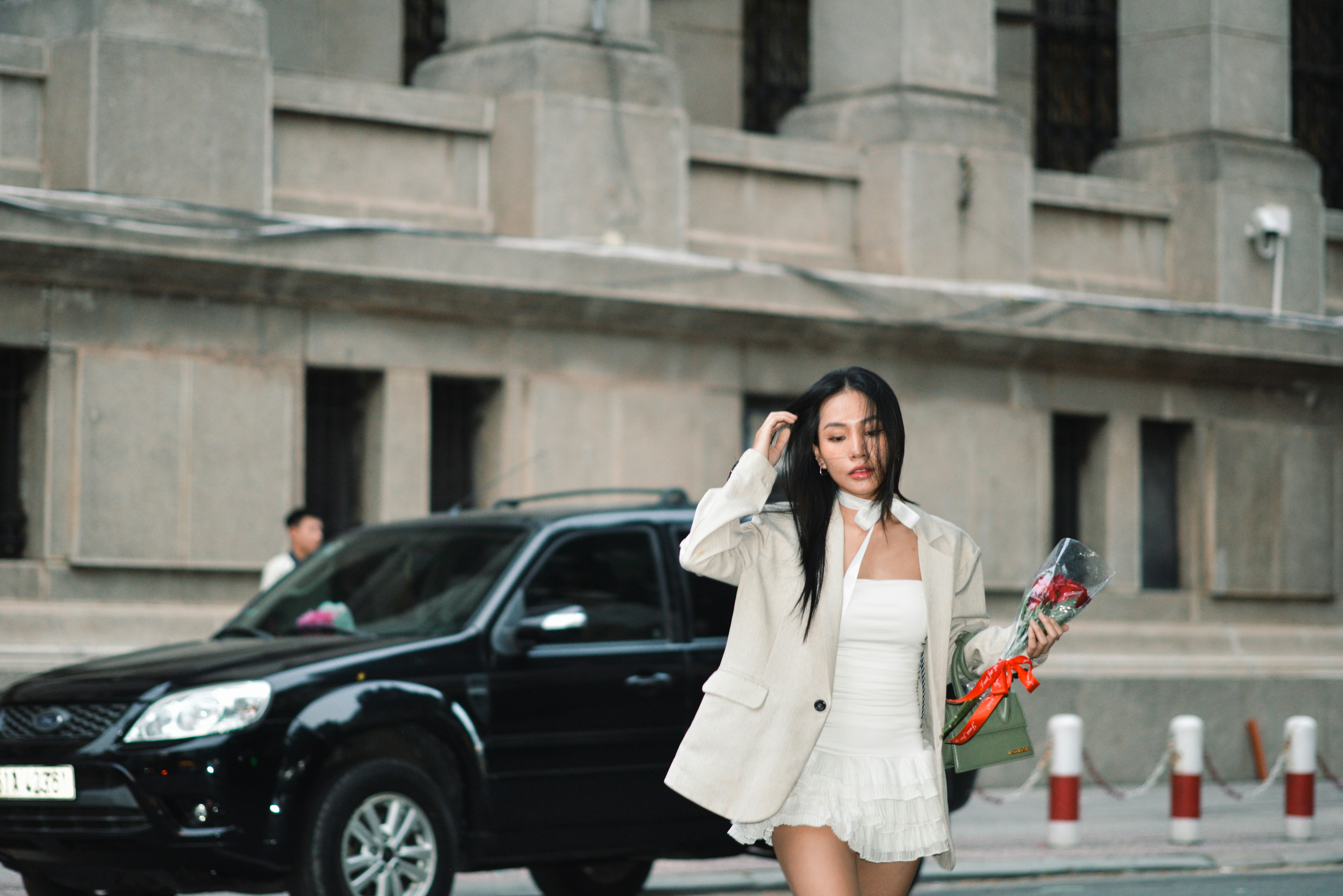 A woman in a white dress is walking down the street photo – Free Girl ...
