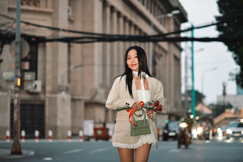 a woman walking down a street holding a cup of coffee
