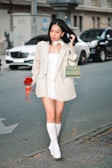 a woman walking down a street holding a purse