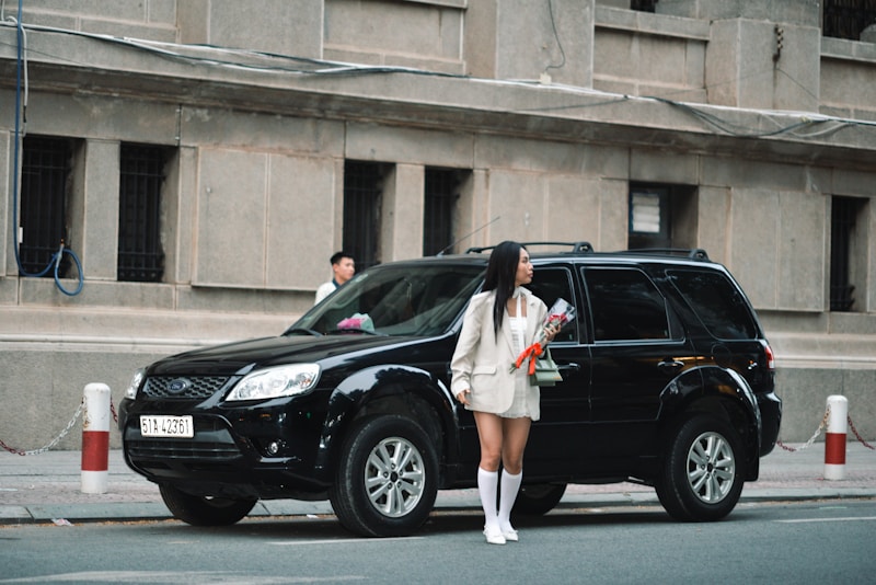 a woman standing in front of a black suv