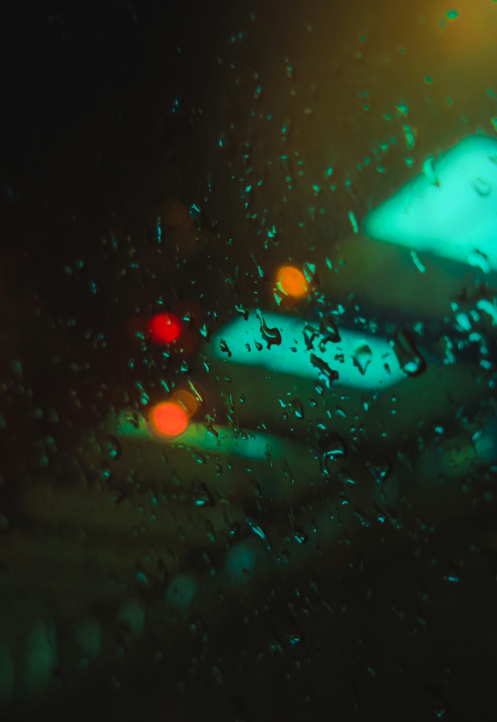 a close up of a car's windshield with rain drops