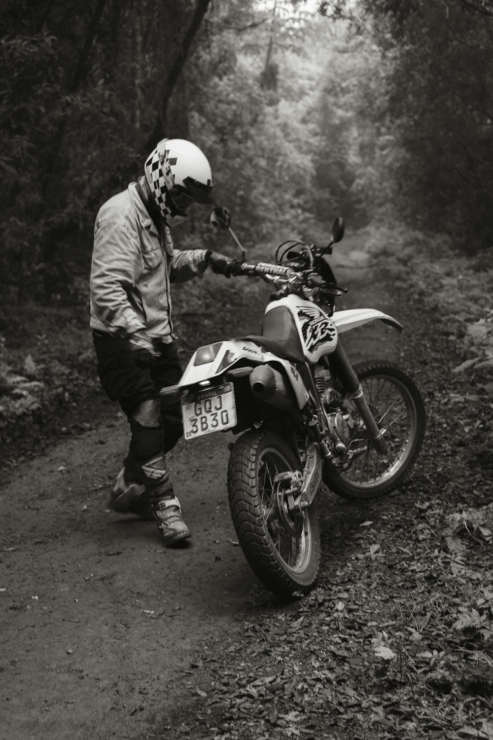 a person on a dirt bike on a trail