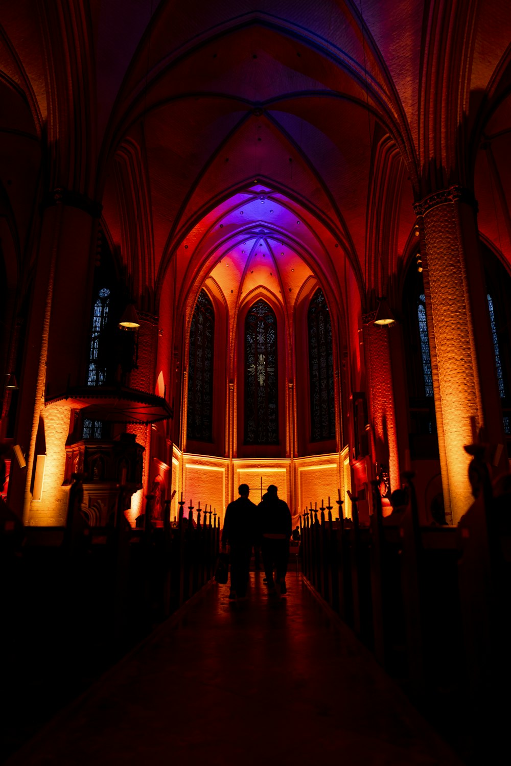 a couple of people standing in front of a church