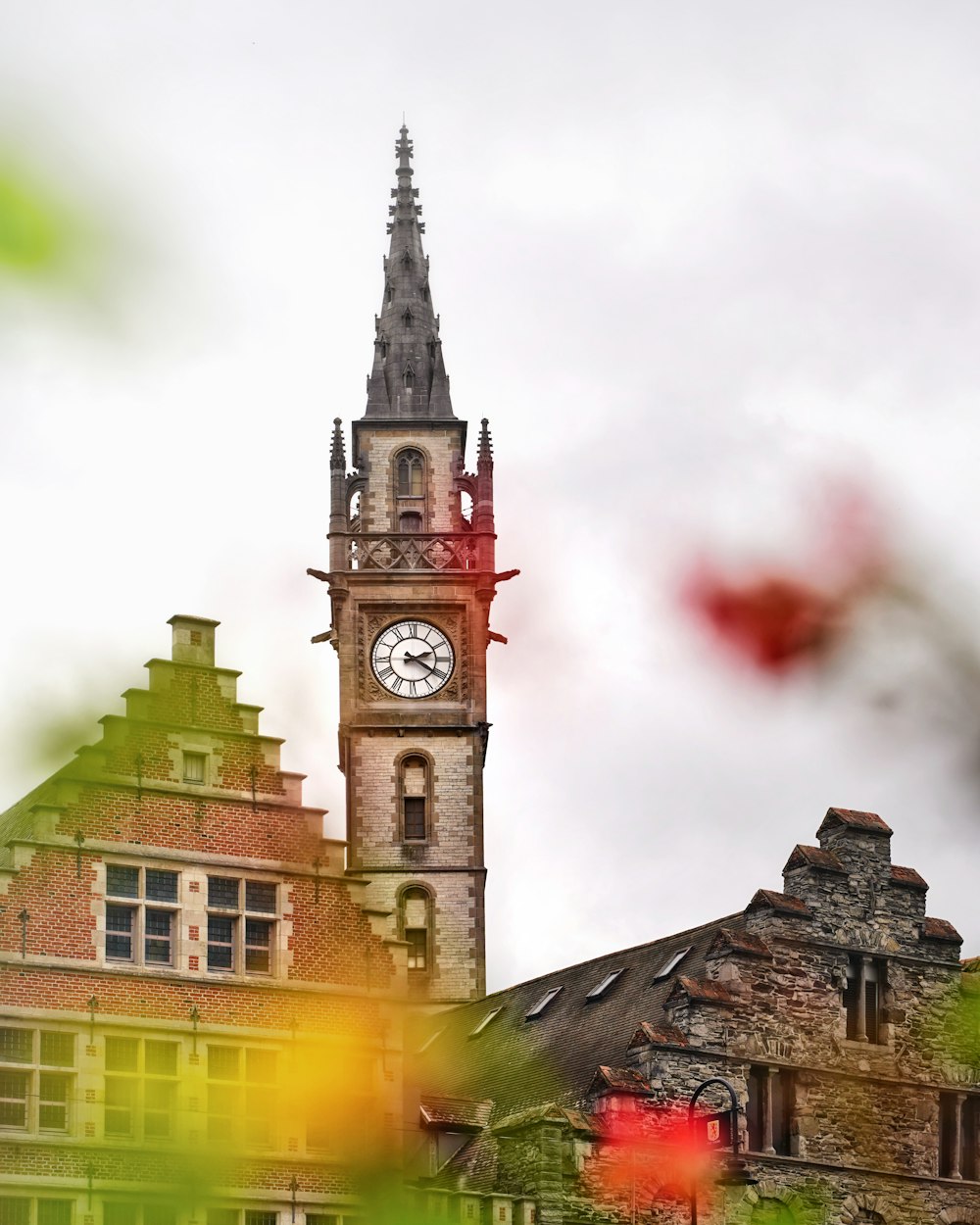 a tall clock tower with a clock on each of it's sides