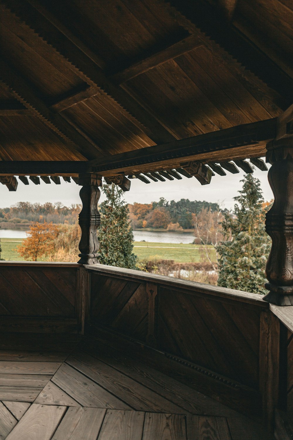 a wooden porch with a view of a lake