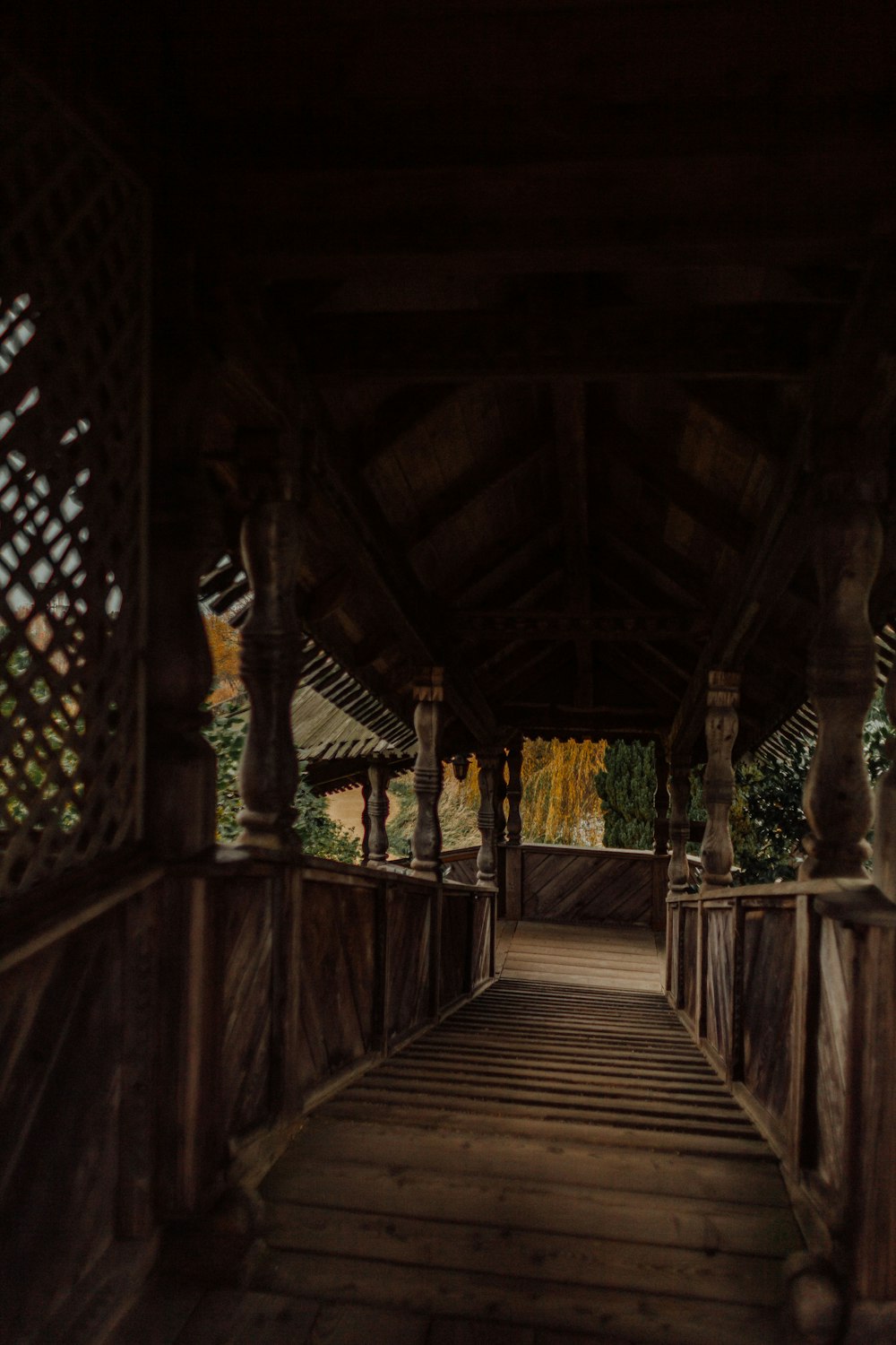 a wooden walkway leading to a covered area
