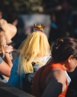 A joyful group photo of María José with her chambelanes under golden sunlight.