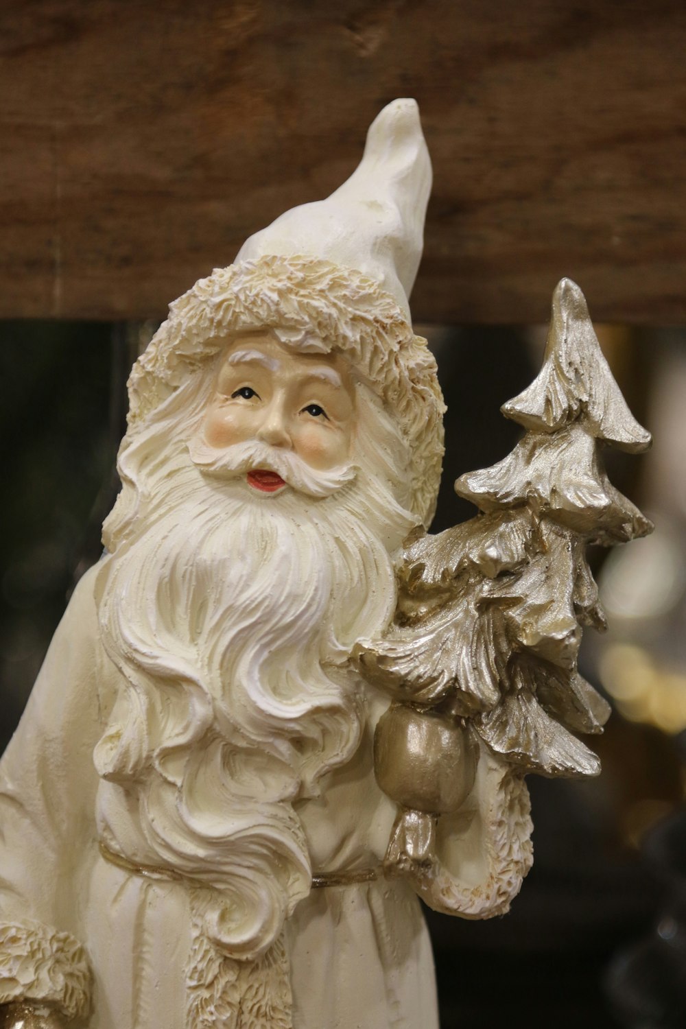 a statue of a santa holding a christmas tree