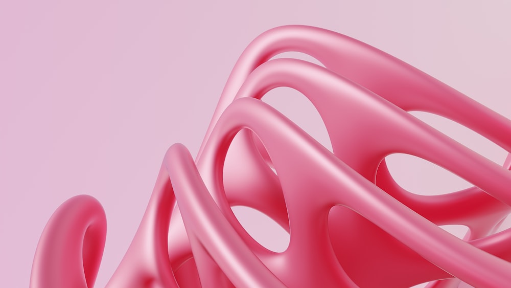 un primer plano de un objeto rosa sobre un fondo rosa