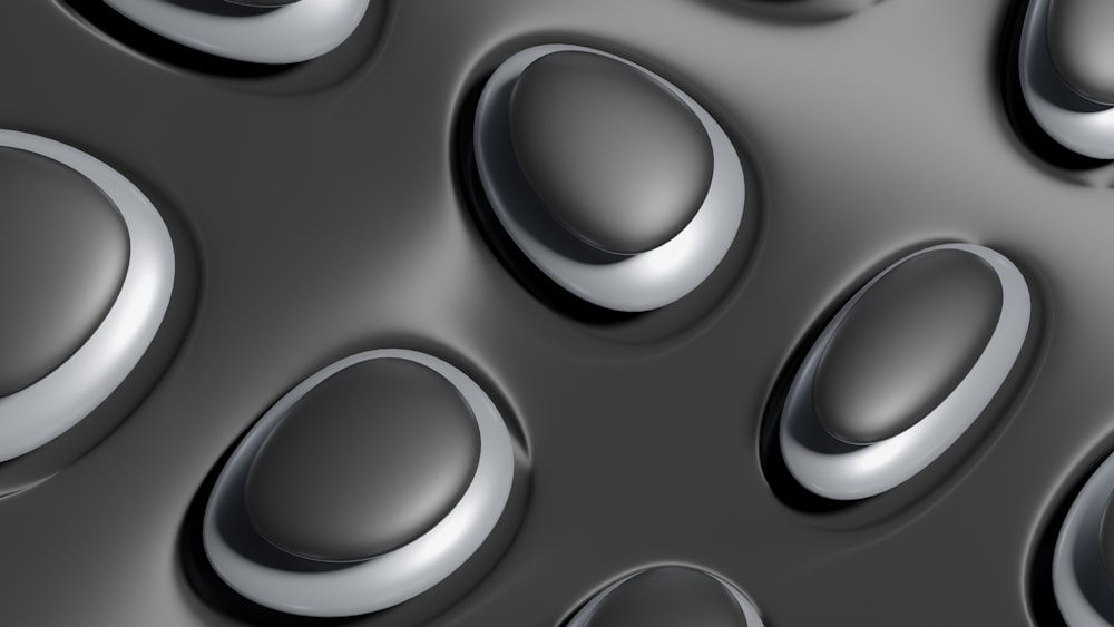 a close up of a metal surface with many circles