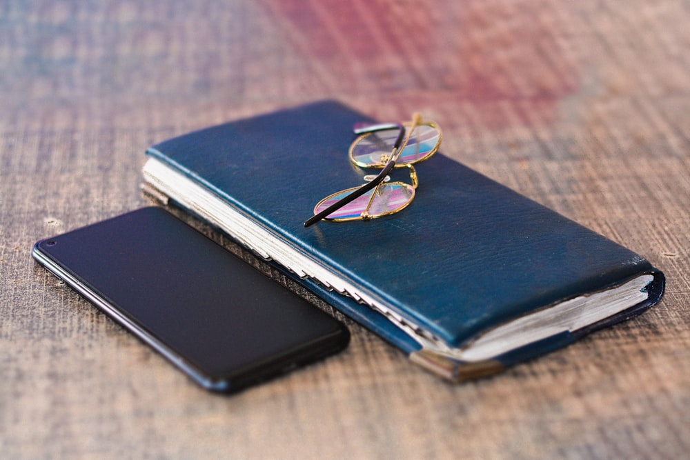 a pair of glasses sitting on top of a book