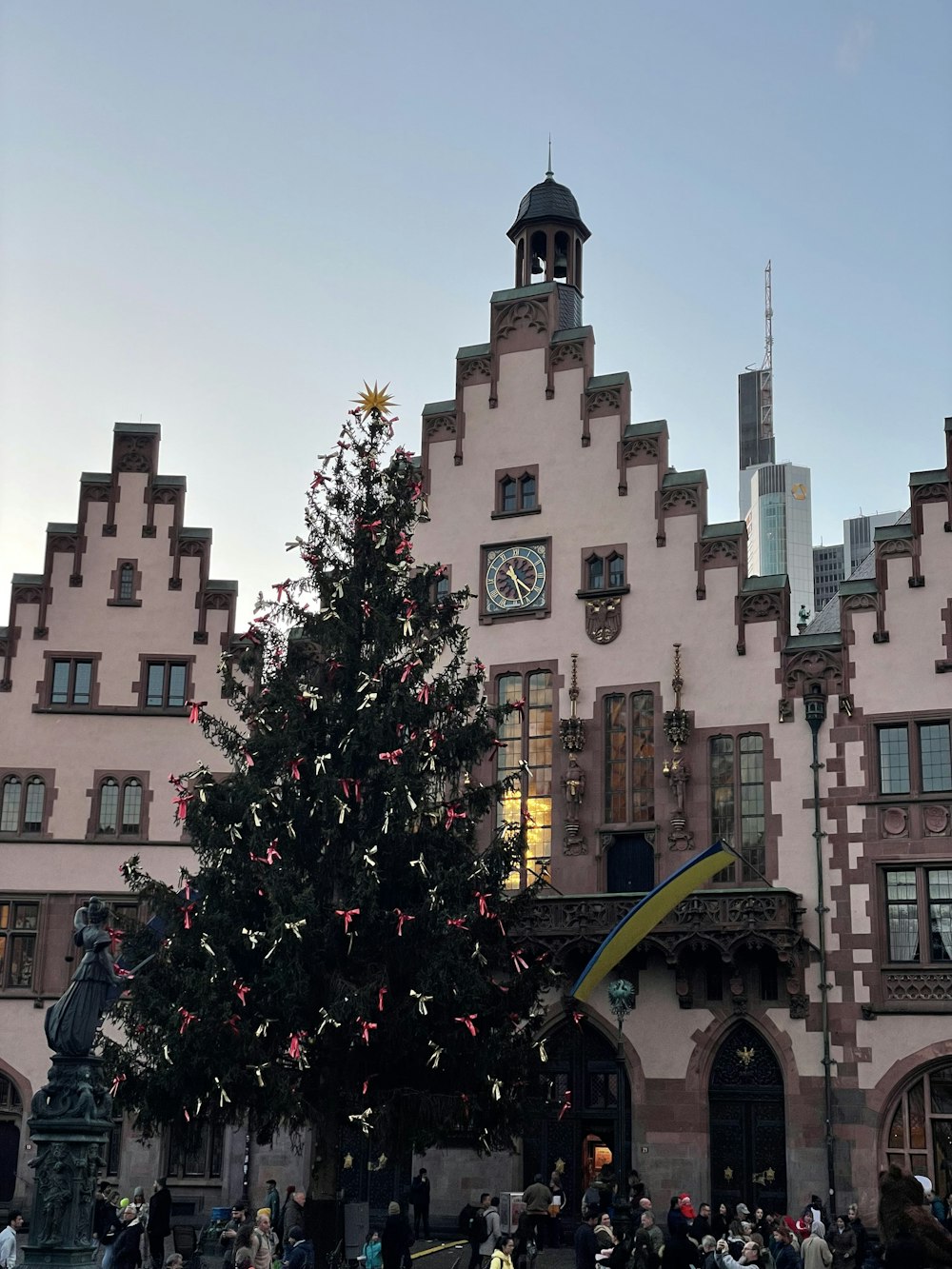 a large christmas tree in front of a building