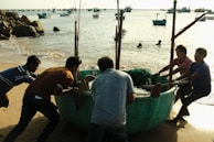 Staff assisting with the gentle launch of a boat into the lake.