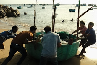 Staff assisting with the gentle launch of a boat into the lake.