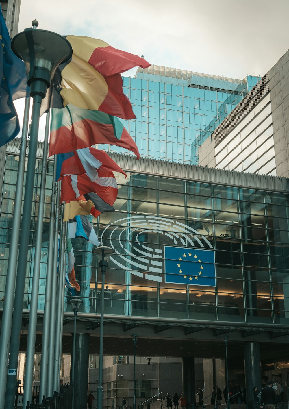 a group of flags flying in front of a building