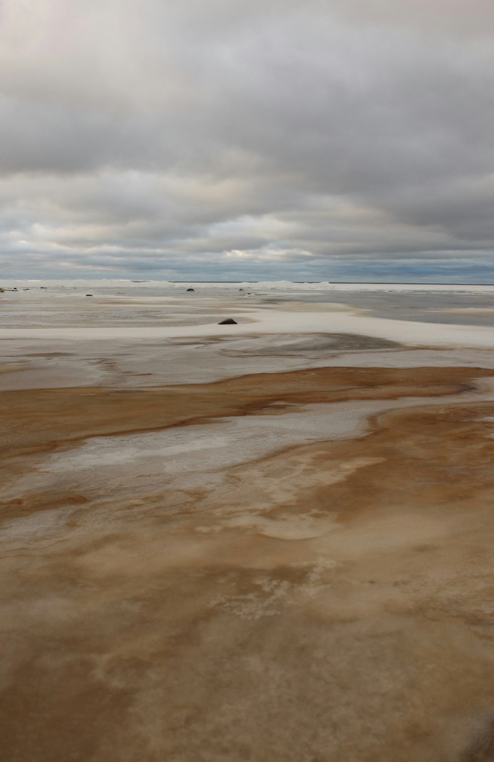 a view of a barren area with a few clouds in the sky