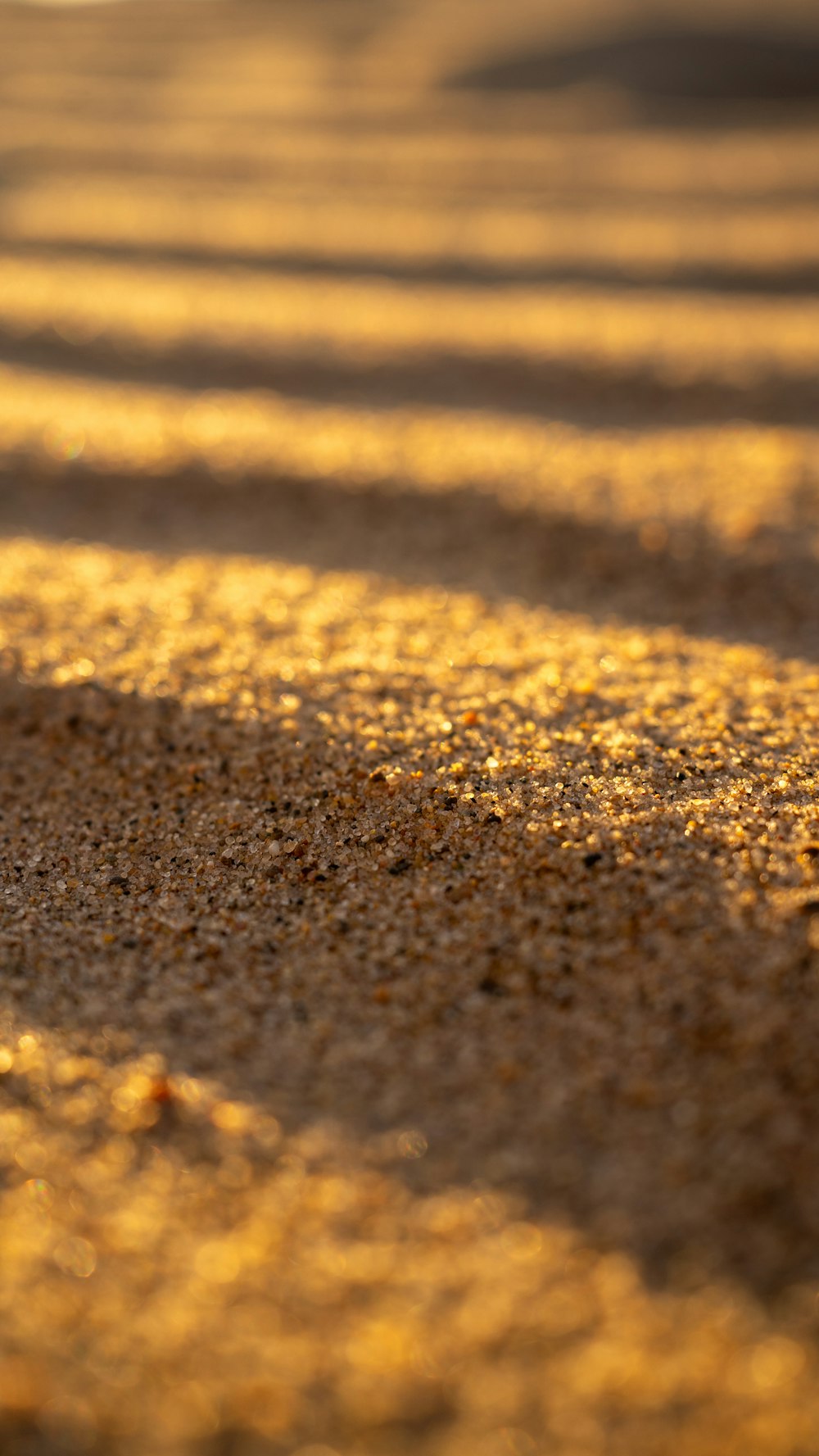 a close up of sand and water on a beach