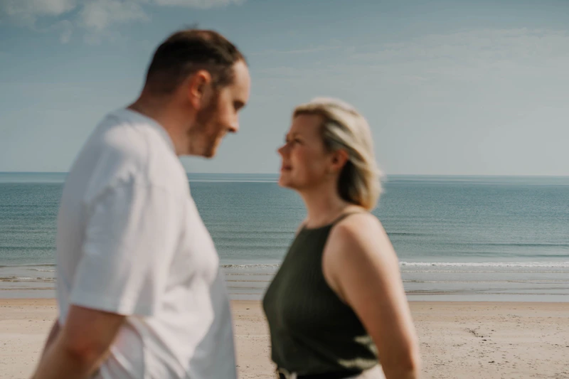 man and woman enjoying time together on beach
