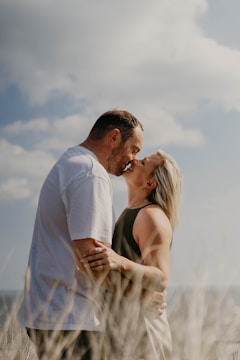 An intimate moment between a couple in a natural outdoor setting.