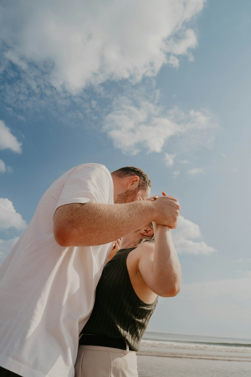 a man and a woman standing on a beach