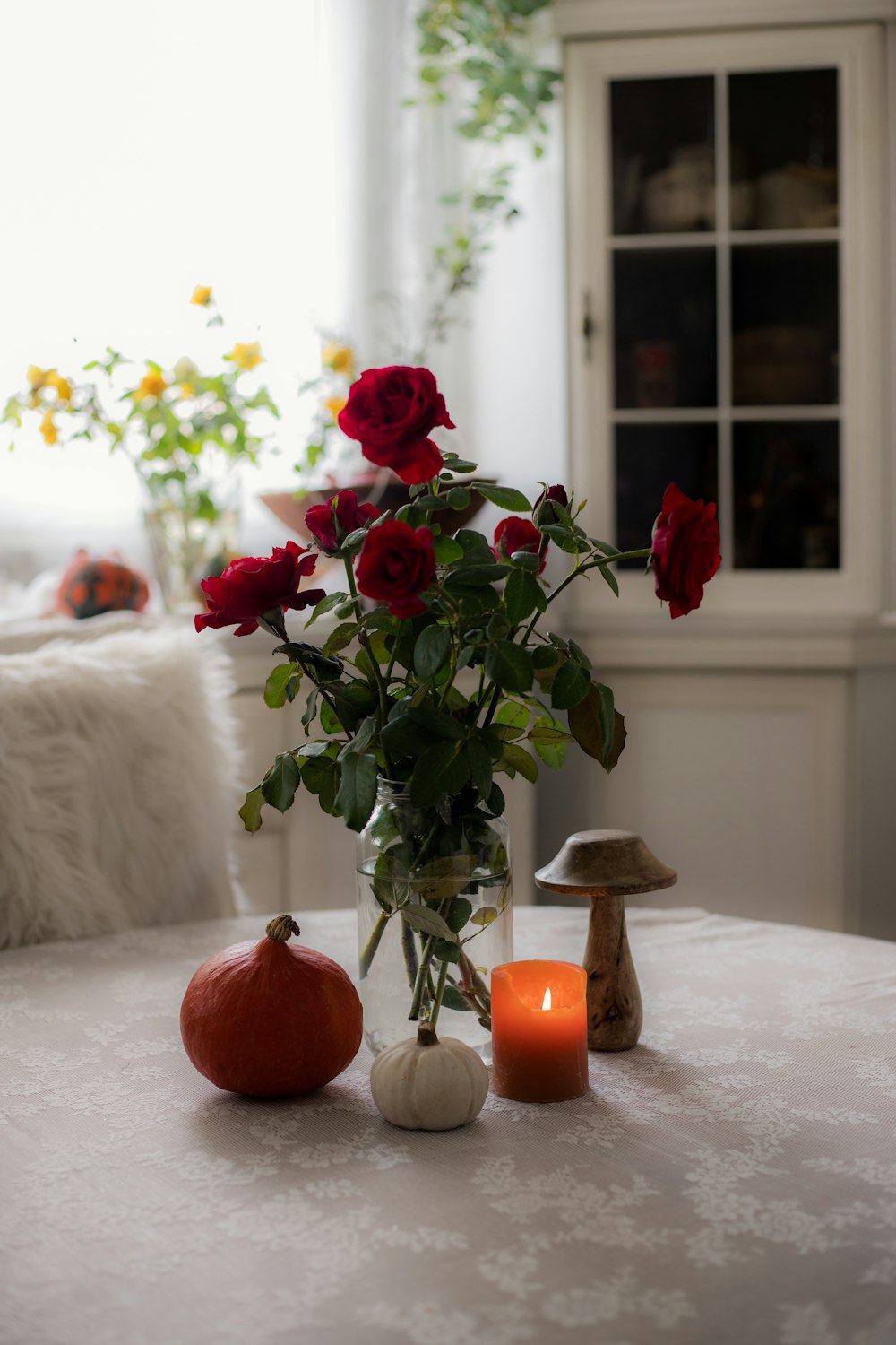 a vase filled with roses sitting on top of a table