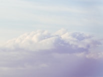 Soft lilac clouds drifting gently over a minimalist celestial sky with twinkling stars.