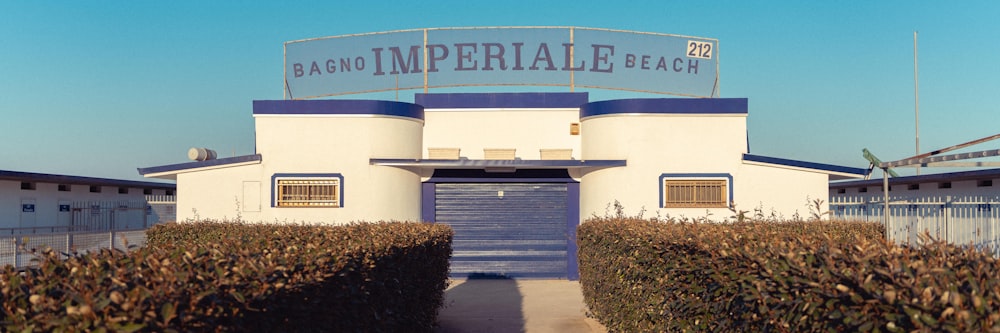 a building with a blue and white roof and a blue door