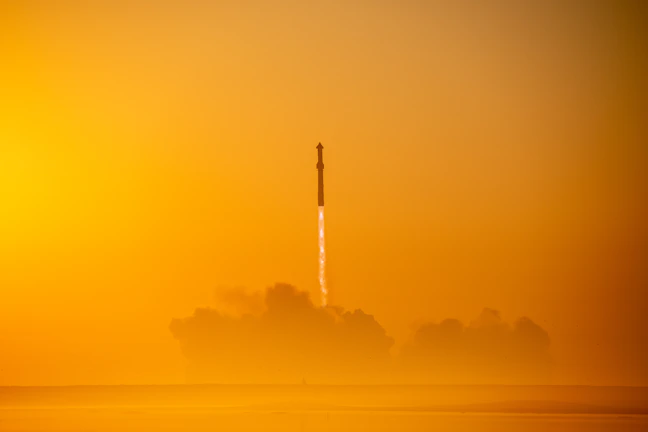 Young students observing a rocket launch at dusk with excitement.