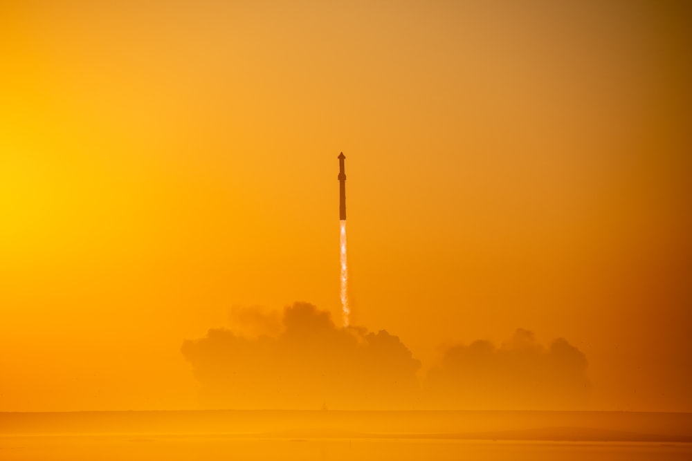 a rocket is flying through the air on a foggy day