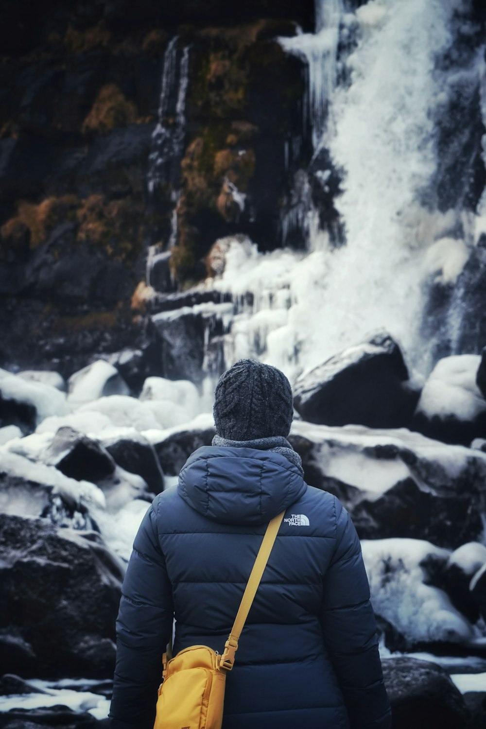 a person standing in front of a waterfall