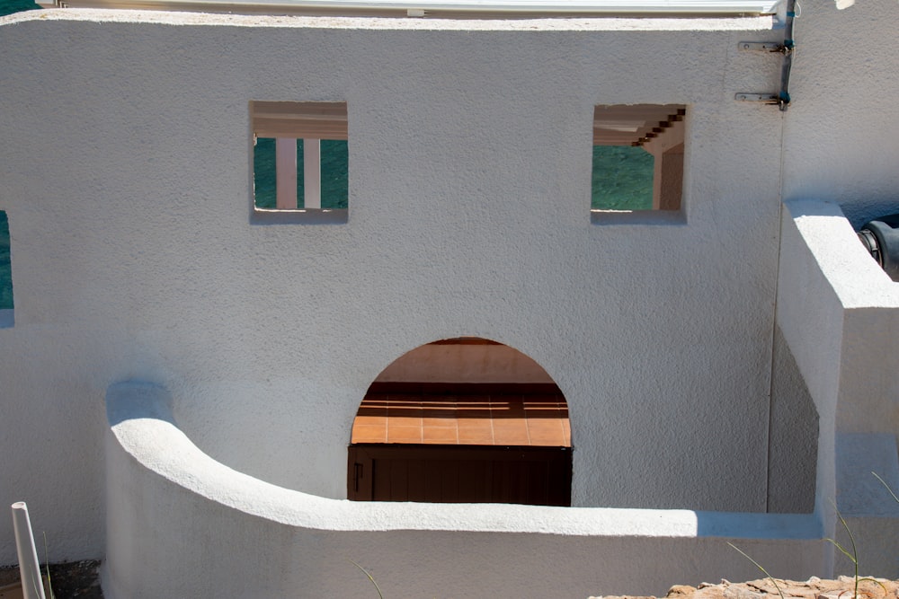 a white building with a door and a window