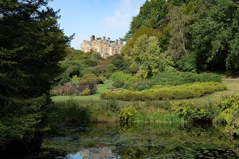 a large building sitting on top of a lush green hillside