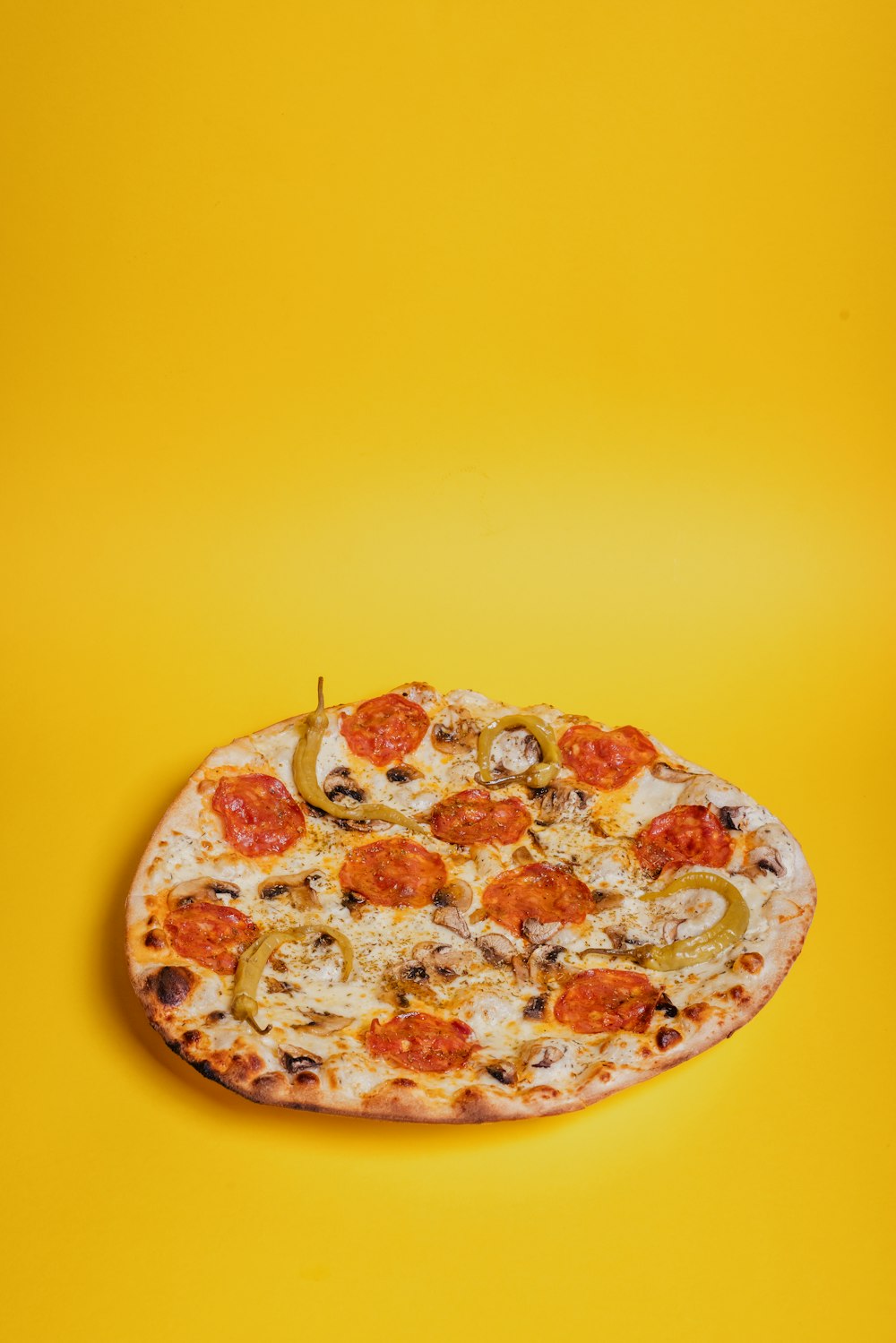 a pizza sitting on top of a yellow table